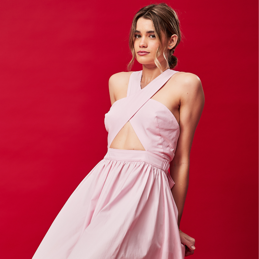 Model in pink dress on red background