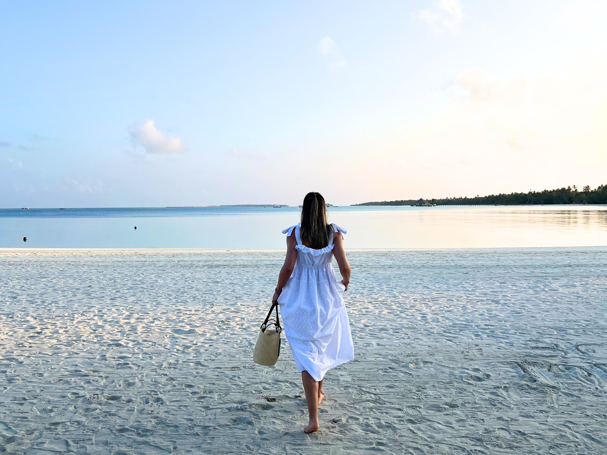 Women in white dress on the beach