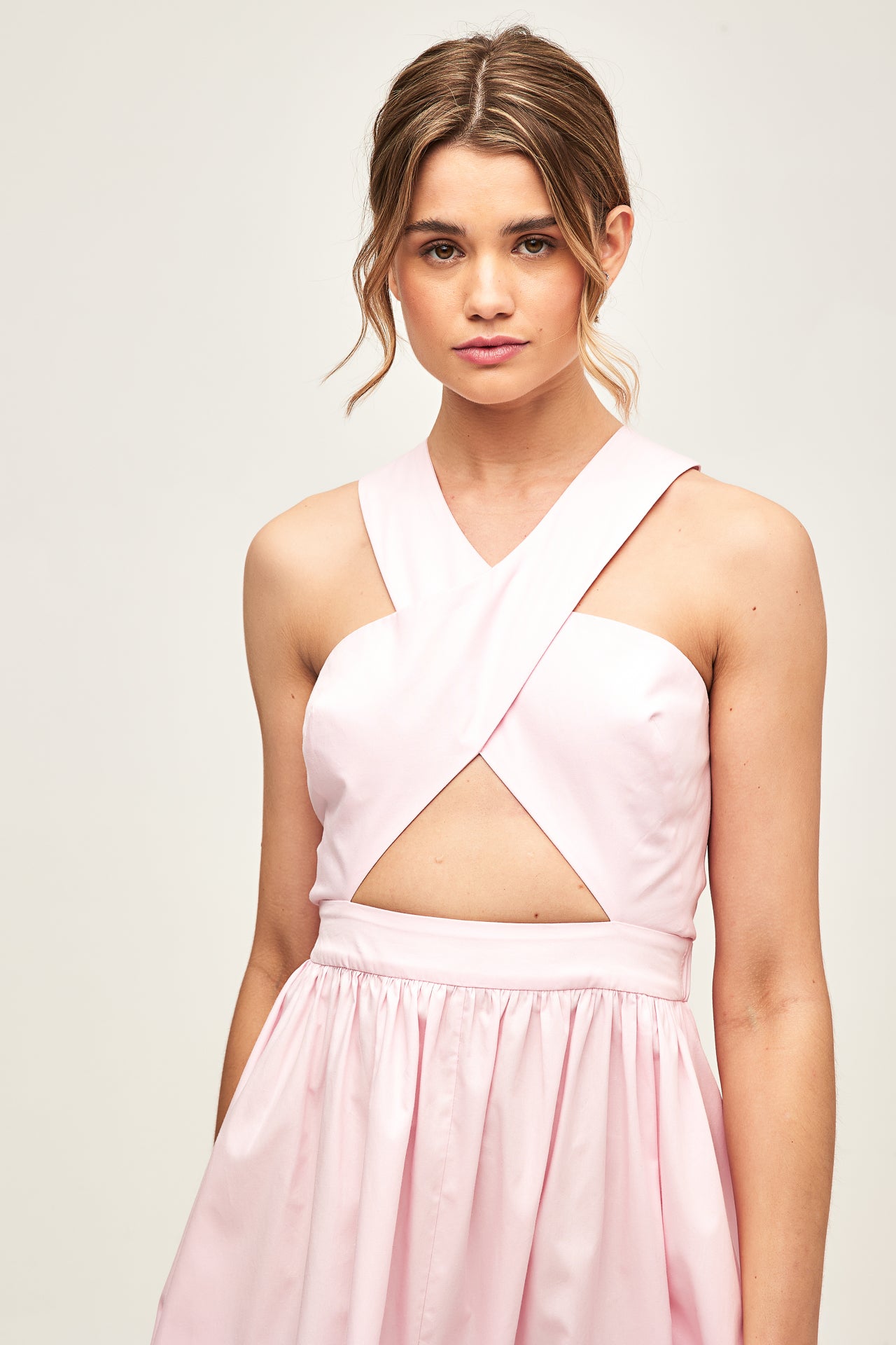 model wearing a baby pink dress front focus