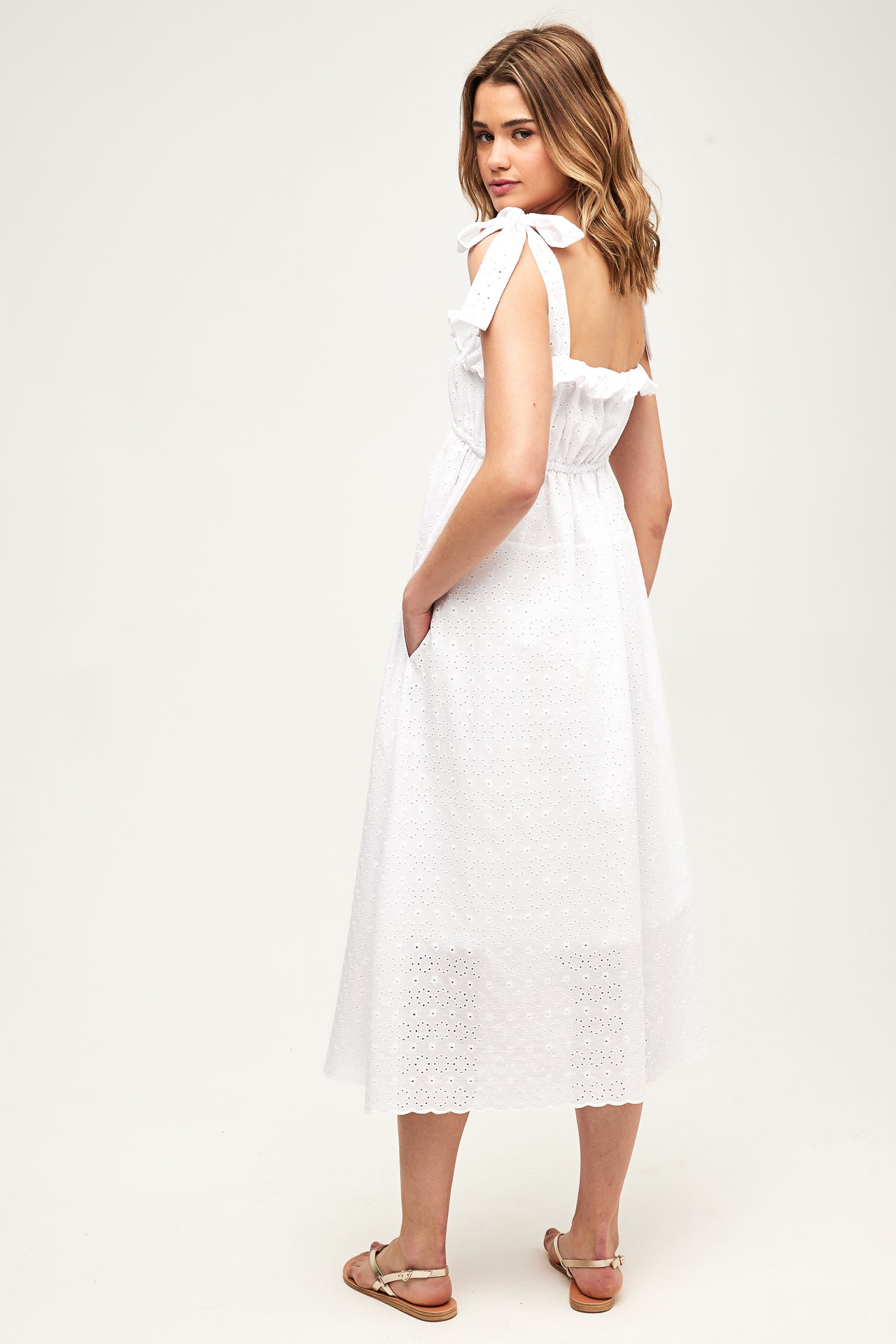 model wearing a white dress from the back