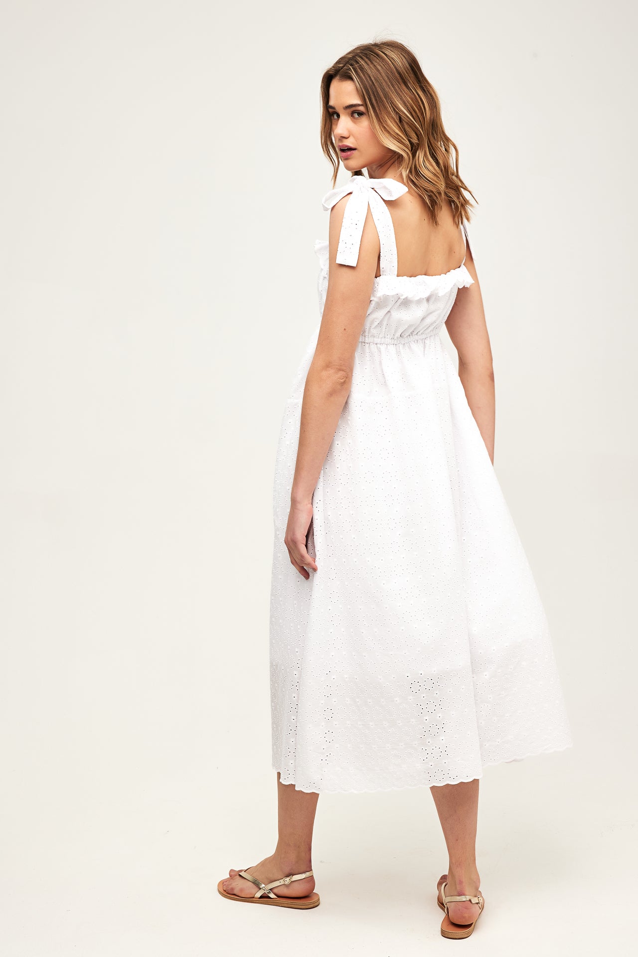 model wearing a white dress from the side