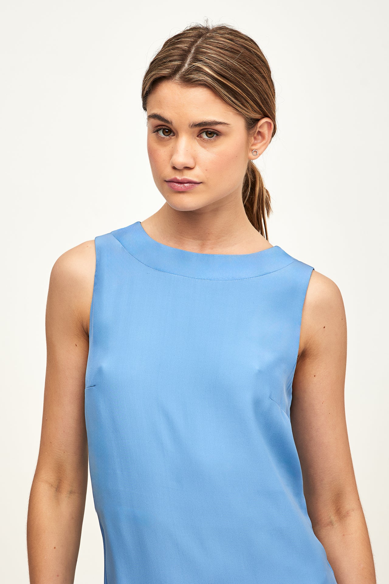 model wearing blue dress on white background