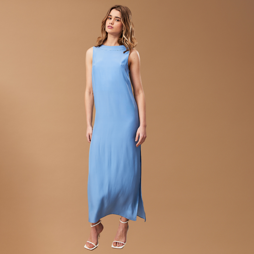 Model in blue dress on brown background