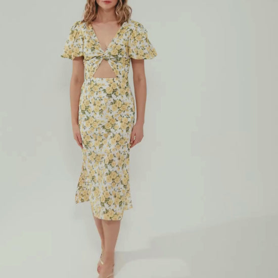 E-commerce video with a model waling in a white dress with yellow roses 